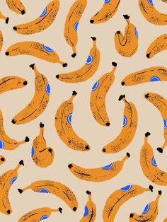 a lot of bananas that are on a beige background with blue dots and black spots