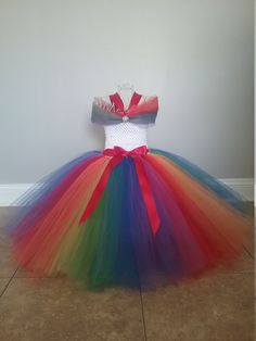 "This is a Over the Top Rainbow Tutu Dress size 12-24 Months to size 14. This dress is made with several layer of high quality tulle in rainbow colors. Please send measurement from arm pit to where you want the dress to hit at the bottom. This dress is very full and would be great for weddings or pictures. If you need a larger size just send me a message. Dress will not be floor length unless you send measurements. Size Chart for Dress Length (from armpit to bottom of dress): 12-24 Months------- Fitted Multicolor Tulle Dress, Multicolor Tulle Skirt Dress, Princess Style Multicolor Tulle Dress, Fitted Rainbow Princess Dress, Rainbow Tulle Princess Dress For Party, Fitted Multicolor Princess Tutu Dress, Multicolor Tulle Skirt Tutu Dress For Dress-up, Fitted Multicolor Tulle Princess Dress, Rainbow Fitted Tutu Dress For Party