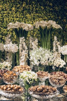 an assortment of desserts and flowers on display