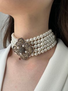 ❤️Introducing our exquisite Handmade Bridal Bridesmaid Pearl Choker - a timeless blend of elegance and sophistication that is bound to elevate any special occasion. This stunning multi-strand/layered choker necklace is meticulously crafted to add a touch of refined glamour to your bridal or bridesmaid ensemble. ❤️Each lustrous pearl is carefully selected and strung together to create a masterpiece that captures the essence of grace and beauty. The multi-layered design not only enhances the neckl Elegant Pearl Necklace With Intricate Design, Elegant Round Pearl Necklace With Intricate Design, Elegant Choker Jewelry With Intricate Design, Vintage White Pearl Chain Jewelry, Ornate Choker Necklace For Wedding, Elegant White Necklace With Intricate Design, Handmade Elegant Round Bridal Necklace, Elegant Handmade Round Bridal Necklace, Antique Round Pearl Necklace For Wedding