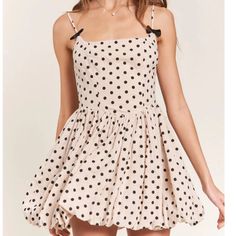 Get Ready To Turn Heads In The Nicolette Polka Dot Mini Dress! This Dress Features A Flattering Square Neckline And A Playful Bubble Hem. The Back Zip Closure Ensures A Secure Fit, While The Bow Detail On The Straps Adds A Charming Touch. With Adjustable Straps And All Over Polka Dot Detailing, This Dress Is Both Versatile And Stylish. Polka Dot Mini Sundress For Summer, Polka Dot A-line Mini Dress For Summer, Polka Dot Mini Dress For The Beach, Chic Polka Dot Mini Dress For Summer, Polka Dot Summer Mini Dress, Polka Dot Mini Dress For Beach, Feminine Polka Dot Dress For Brunch, Flirty Polka Dot Mini Dress For Summer, Polka Dot Mini Dress For Summer