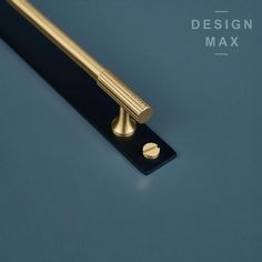 an image of a brass handle on a blue background with the words design max above it