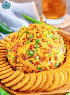 a cheese ball with crackers on a wooden platter