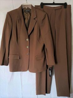 KASPER 14 Dark Camel Brown 2-Pc Blazer & Lined Pants Suit NWT $280 X X Click to Enlarge Click to Enlarge Kasper makes a classic suit and this one is timeless. From the Indian Summer collection, it is well made and can be worn year-round. 64% Polyester, 32% Viscose, 4% Spandex 100% Polyester lining Dry clean 3 button front closure on jacket Notched collar Padded shoulders Bust 44" Length of jacket center back to hem 27" Pants have front fly with flat hook/eye closure and inside button Unopened side hip welt pockets Inseam 31.5" NWT, new with tags MSRP $280.00 You don't have to spend hundreds of dollars for name brand clothing. I have some wonderful clothing that is new and in perfect condition (unless otherwise noted) that I'm offering at considerable discounts off department store retail. Brown Workwear Sets With Suit Collar, Classic Brown Office Wear Set, Classic Career Suits In Solid Color, Classic Solid Color Career Suit, Classic Solid Suits For Career, Fitted Brown Formal Pantsuit, Elegant Brown Workwear Sets, Fitted Brown Workwear Set, Fitted Brown Set For Workwear