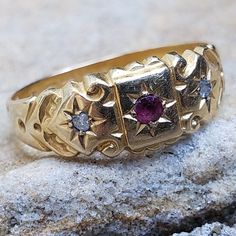 This Victorian Ring is a treasure today as it was when it was made in 1863.  The ring is hallmarked on the inside of the band and it tells it's story through those hallmarks. The ring is made out of a rich, warm buttery 18K Yellow Gold and is set with one ruby and two old mine cut diamonds. The round ruby measures 2mm round and is estimated 0.07 cts. The two diamonds on either side are natural and original to the ring. The cut of the diamonds is old mine cuts.  Jewellery throughout the Victorian Antique Gold Ruby Ring Stamped 14k, Heirloom Yellow Gold Diamond Ring For Ceremonial Occasions, Victorian Ruby Ring In Stamped 14k Yellow Gold, Victorian Engraved Yellow Gold Ring For Ceremonial Occasion, Victorian Gold Engraved Collectible Ring, Heirloom Gold Ruby Ring For Ceremonial Occasions, Victorian Gold Engraved Ring, Antique Gold Engraved Ring Hallmarked, Antique 14k Stamped Yellow Gold Ruby Ring