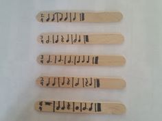 four wooden baseball bats with numbers on them