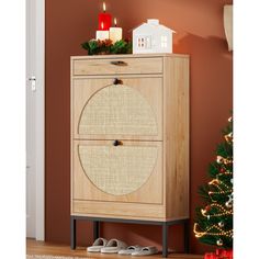 a wooden cabinet sitting next to a christmas tree