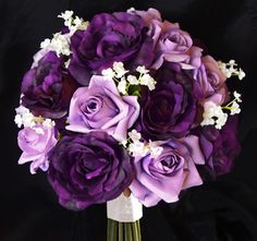 a vase filled with purple and white flowers