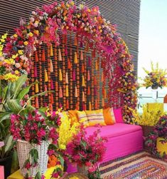 an outdoor seating area decorated with flowers and plants