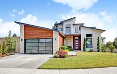 a large house with two garages in the front yard