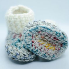 two crocheted baby booties sitting next to each other