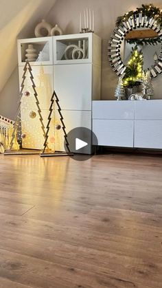 a living room filled with furniture and christmas trees on top of wooden flooring in front of a window