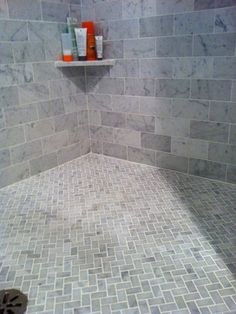 a tiled shower with shelves above it