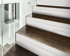 a set of wooden stairs with glass railing