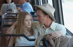 a man sitting next to a woman on a bus