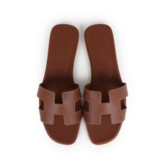 This pair of Oran Sandals are in Gold calfskin leather with contrast stitching, a natural leather insole and feature the iconic H crossover strap. Origin: ItalyCondition: New and never wornAccompanied by: Hermes box, dustbags, carebook and ribbonSize: 37.5 EU Sandals With Small Heel, Classic Tan Sandals With Leather Lining, Classic Tan Sandals With Leather Sole, Classic Tan Leather Sandals, Brown Open Heel Calf Leather Mules, Classic Mules With Leather Lining And Single Toe Strap, Brown Mules With Single Toe Strap And Branded Insole, Designer Brown Calf Leather Sandals, Classic Mules With Single Toe Strap And Leather Lining