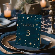 a table setting with place cards and candles