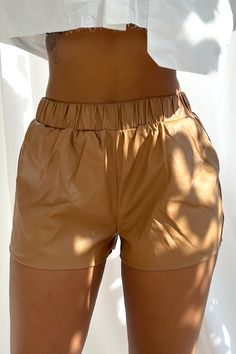 High-waisted vegan faux leather shorts with flare A-line cut Stretchy scrunched waistband and side pockets Slip on closure Runs true to size 55% Polyester 45% Polyurethane Model is in size S Height: 5'7" Bust: 32" Waist: 26" Hips: 38" Trendy Faux Leather Bottoms With Built-in Shorts, Brown Faux Leather Short Bottoms, Brown Faux Leather Shorts For Spring, Brown Faux Leather Shorts, Trendy Faux Leather Bottoms For Summer, Faux Leather Short Bottoms For Fall, Faux Leather Shorts For Fall, Short Faux Leather Bottoms For Fall, Fall Faux Leather Short Bottoms