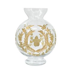 a glass vase with gold designs on it