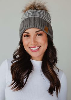 The pom hats EVERYONE loves! Our popular knit pom hats are a must have in your winter closet! You'll reach for this fun winter accessory time and time again this season. Taupe and white striped knit pom hat Natural faux fur pom accent Fleece lined Crown patch on the left side One size Designed in the U.S.A. Produced in China. 100% Acrylic Casual Pom Pom Hat For Cold Weather, Cold Weather Hats With Pom Poms, Pom Hats, Knitted Hats Kids, Knit Hat For Men, Knit Jewelry, Winter Closet, Casual Bottoms, Winter Hats For Women