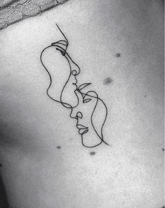 a woman's stomach with a line drawing of two faces on the side of her belly