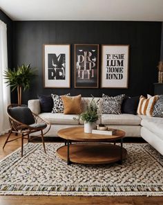 a living room with black walls, white couches and wooden coffee table in the middle