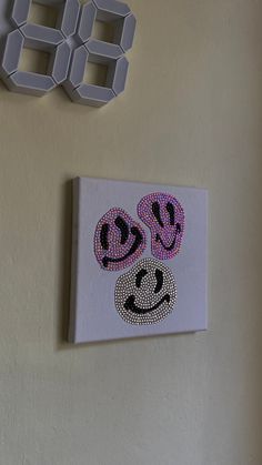 a white wall with a smiley face on it and two numbers hanging on the wall