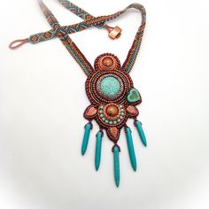 A gorgeous dream in bright and vibrant colors is this handmade unique piece: Boho beadwork necklace in turquoise and copper with a touch of purple, howlite cabochon and daggers and many tiny glass beads make a great eye-catcher that many will envy you for!!  Necklace length:  appr. 50 cm (20 inch) Pendant: 13 x 6 cm (5 x 2.3 inch) Colors: turquoise, copper, purple Material: turquoise dyed howlite, glass beads in various shapes (Miyuki, Preciosa) Clasp: toggle clasp with copper plated glass bead Artisan Beaded Turquoise Pendant Necklace, Unique Turquoise Beaded Necklace With Pendant, Unique Turquoise Pendant Beaded Necklace, Unique Turquoise Pendant Beaded Necklaces, Turquoise Pendant Beaded Necklace, Handmade Turquoise Beaded Necklaces, Bohemian Turquoise Pendant Beads, Unique Handmade Turquoise Beaded Necklaces, Artisan Turquoise Beaded Necklaces For Crafting