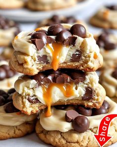 chocolate chip cookies are stacked on top of each other with white frosting and caramel drizzle