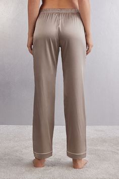 Full length pants in light stretch silk satin with contrast trim, available in different colors, at the hem. Elegant and comfortable, they are perfect for a nighttime outfit or refined loungewear. Elegant Satin Pants For Loungewear, Elegant Wide Leg Bottoms For Pajama Party, Elegant Silk Loungewear Bottoms, Satin Trousers For Loungewear, Fitted Satin Finish V-neck Sleepwear, Elegant V-neck Sleepwear With Satin Finish, Satin Wide-leg Loungewear Bottoms, Silk V-neck Sleepwear For Bedtime, Elegant Silk V-neck Sleepwear