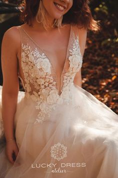 a woman in a wedding dress posing for the camera