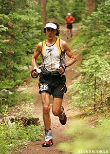 a man running down a trail in the woods