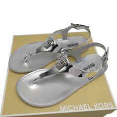 Michael Kors Mira Jelly Flat Thong Sandal Silver Store Style: #40t7mifa1q Color: Silver Metallic Pvc. 0.3" Flat Heel. Thong Strap. T-Strap Vamp With Padlock. Adjustable Slingback Strap. Brand New With Box 100% Authentic Jelly Flats, Michael Kors Shoes, Jelly Sandals, Thong Sandals, T Strap, Jelly, Women's Shoes Sandals, Shoes Sandals, Metallic Silver