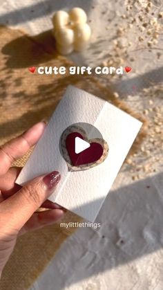 someone holding up a card with a heart on it and the text cute gift card