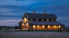 a large house lit up at night in the country