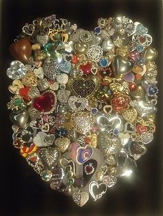 a heart shaped box filled with lots of charms