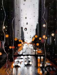 rain drops on the window glass with buildings in the background