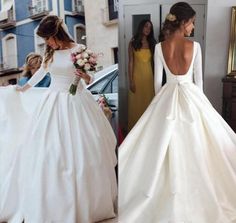 the back of a white wedding dress with long sleeves and a bow at the waist