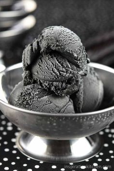 a metal bowl filled with black ice cream