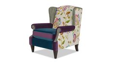 an upholstered wingback chair with floral fabric and purple trimmings on the back