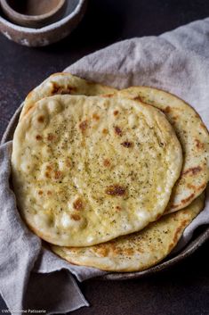 two pita breads sitting on top of a cloth