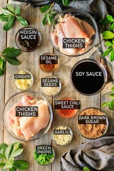 the ingredients for chicken thighs in bowls on a wooden table with herbs and seasonings