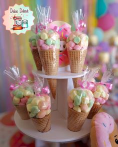 there are some ice cream cones with marshmallows in them