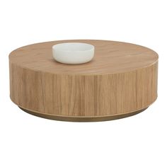 a white bowl sitting on top of a wooden table