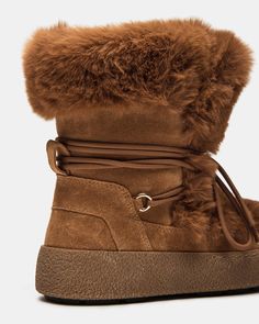 Expertly designed for both style and function, the AVALANCHE ankle boot will keep you warm and on-trend. The bootie style offers comfort and support, while the faux fur adds a touch of luxury. The platform adds height and stability, making these boots perfect for all-day wear. 1.5 inch heel height 15.5 inch shaft circumference 6.25 inch shaft height Suede and faux fur upper material Faux fur lining Faux fur sock Synthetic sole Fit tip: If you are in between sizes, size down a half-size Imported High-top Shearling Winter Boots, High-top Shearling Boots For Winter, Winter High-top Shearling Boots, Winter Shearling Boots With Lug Sole, Brown Winter Boots With Plush Lining, Trendy Winter Boots With Faux Fur Lining, Winter Platform Boots With Faux Fur Trim, Winter Sheepskin Ankle Boots, Winter Ankle Boots With Faux Fur Trim