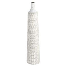 a tall white vase sitting on top of a table