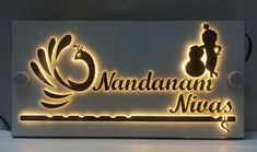 an illuminated sign that reads nandanan niyas with the image of a man riding a horse