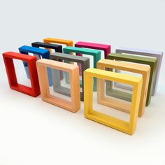 there are many different colored frames on the table