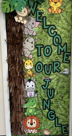 a door decorated with jungle animals and the words welcome to our jungle