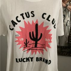 Cute And Soft T-Shirt. Cactus Club By Lucky Brand Pretty Salmon, Color Sun With Black Cactus And Lettering Never Worn Size Large Bundle Discount Offered Posh Ambassador. Cactus Branding, Cactus Club, Black Cactus, Discount Offer, Salmon Color, Lucky Brand, Tee Shirt, Cactus, Tee Shirts